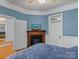 Blue bedroom with fireplace, built-ins, and hardwood floors at 510 5Th St, Spencer, NC 28159