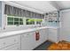 Bright kitchen with white cabinets, dishwasher, and window overlooking backyard at 510 5Th St, Spencer, NC 28159