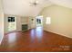 Open living room featuring hardwood floors, fireplace, and vaulted ceilings at 6613 Rain Creek Way, Charlotte, NC 28262