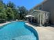 Inviting kidney-shaped pool with a pool house and patio furniture at 127 Tranquil Ct # 18A, Locust, NC 28097
