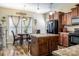 Kitchen with an island, dark wood cabinets and black appliances at 127 Tranquil Ct # 18A, Locust, NC 28097