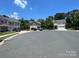 Community view showing homes with yards and street at 127 Tranquil Ct # 18A, Locust, NC 28097