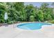 Enjoy this kidney shaped pool with a spacious patio area at 127 Tranquil Ct # 18A, Locust, NC 28097