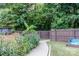 Curved walkway through lush landscaping with wooden fence at 127 Tranquil Ct # 18A, Locust, NC 28097