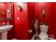 Stylish powder room with a red accent wall and modern fixtures at 127 Tranquil Ct # 18A, Locust, NC 28097