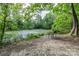 Serene pond view with a bench and lush green surroundings at 127 Tranquil Ct # 18A, Locust, NC 28097