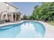Large kidney shaped pool with a covered patio and seating area at 127 Tranquil Ct # 18A, Locust, NC 28097