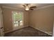 Bright bedroom with french doors leading to the backyard and neutral carpeting at 310 Chaney St, Wingate, NC 28174