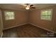 Well-lit bedroom with two windows and wood-look flooring at 310 Chaney St, Wingate, NC 28174