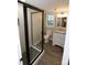 Basement bathroom with granite vanity, walk-in shower, and neutral flooring at 310 Chaney St, Wingate, NC 28174