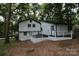 Updated house exterior with deck and wooded lot at 310 Chaney St, Wingate, NC 28174