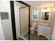 Basement bathroom with granite vanity, walk-in shower, and neutral flooring at 310 Chaney St, Wingate, NC 28174