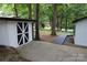 Side yard with shed and walkway leading to the woods at 310 Chaney St, Wingate, NC 28174
