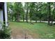Wooded backyard with a tree-lined street view at 310 Chaney St, Wingate, NC 28174