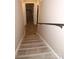 Basement stairs with hardwood treads and black railing at 310 Chaney St, Wingate, NC 28174