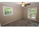 Spacious bedroom with a window, french doors, and neutral carpeting at 310 Chaney St, Wingate, NC 28174