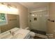 Clean bathroom with a walk-in shower and white tile at 310 Chaney St, Wingate, NC 28174