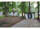Landscaped backyard with two sheds and a wooded area at 310 Chaney St, Wingate, NC 28174