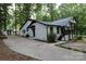 Home's side view showcasing a driveway and detached shed at 310 Chaney St, Wingate, NC 28174