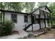 Charming home exterior with black and white accents and a deck at 310 Chaney St, Wingate, NC 28174