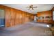 Open living room with wood paneling and a view into the kitchen area at 1418 Oakwood Ave, Kannapolis, NC 28081