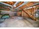 Unfinished basement with stairs and built-in shelving at 1418 Oakwood Ave, Kannapolis, NC 28081