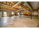 Spacious unfinished basement with stone fireplace and exposed beams at 1418 Oakwood Ave, Kannapolis, NC 28081