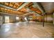 Spacious unfinished basement with stone fireplace and exposed beams at 1418 Oakwood Ave, Kannapolis, NC 28081