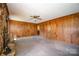 Spacious living room with wood paneled walls and a stone fireplace at 1418 Oakwood Ave, Kannapolis, NC 28081