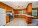 Kitchen boasts wood cabinets, a breakfast bar, and tiled floors at 1418 Oakwood Ave, Kannapolis, NC 28081