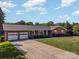 Brick ranch house with attached two-car garage and landscaped yard at 1418 Oakwood Ave, Kannapolis, NC 28081