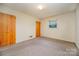 Bright bedroom with carpet, window and closet at 1418 Oakwood Ave, Kannapolis, NC 28081