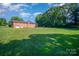 Spacious backyard with a large grassy area and mature trees at 1418 Oakwood Ave, Kannapolis, NC 28081