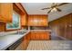 Kitchen features wood cabinets, tiled floors, and a view of the dining area at 1418 Oakwood Ave, Kannapolis, NC 28081