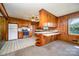 Kitchen with wood cabinets, tiled floors, and stainless steel appliances at 1418 Oakwood Ave, Kannapolis, NC 28081