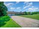 Ranch home with a long driveway and a spacious front yard at 1418 Oakwood Ave, Kannapolis, NC 28081