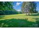 Expansive grassy area with mature trees and natural beauty at 1418 Oakwood Ave, Kannapolis, NC 28081