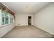 Bright dining room with carpeted floor, chandelier, and view to kitchen at 1418 Oakwood Ave, Kannapolis, NC 28081