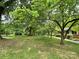 Landscaped yard with mature trees and green grass at 506 Hearne Farm Rd, Mount Gilead, NC 27306