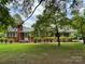 Brick ranch house with mature landscaping and a covered porch at 506 Hearne Farm Rd, Mount Gilead, NC 27306