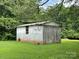 Grey block shed with a wooden garage door at 506 Hearne Farm Rd, Mount Gilead, NC 27306