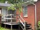 Wooden deck with steps and wrought iron furniture at 506 Hearne Farm Rd, Mount Gilead, NC 27306