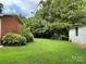 Large backyard with lush green grass and storage shed at 506 Hearne Farm Rd, Mount Gilead, NC 27306