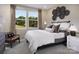 Bedroom with striped bedding, wood chair, and large windows at 2513 Tillman St, Monroe, NC 28112