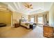 Large main bedroom with plush carpet, a ceiling fan, and plenty of natural light at 2073 Hambridge Ave, Kannapolis, NC 28081