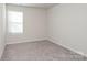 Bright bedroom with neutral carpet and a large window at 3820 Shider Ln, Kannapolis, NC 28081