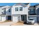 Two-story townhome with gray and white siding, white garage door, and landscaping at 3820 Shider Ln, Kannapolis, NC 28081