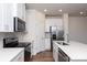 Modern kitchen with white cabinets, stainless steel appliances, and quartz countertops at 3820 Shider Ln, Kannapolis, NC 28081