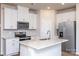 Modern kitchen with white cabinets, stainless steel appliances, and quartz countertops at 3820 Shider Ln, Kannapolis, NC 28081