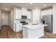 Modern kitchen with white cabinets, stainless steel appliances, and quartz countertops at 3820 Shider Ln, Kannapolis, NC 28081
